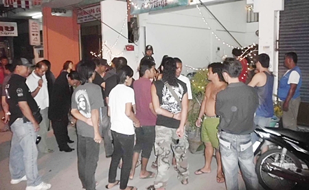 Crowds gather outside the Khrua Mai Man Karaoke where the shooting occurred.
